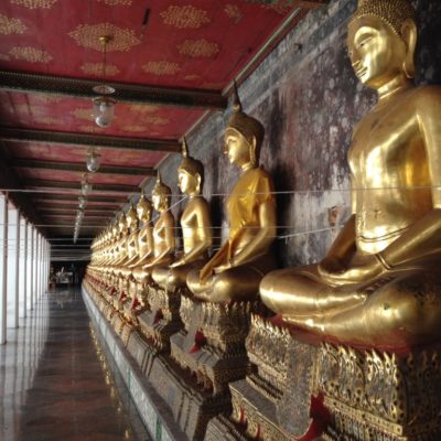 Buddha-Statuen in Meditationshaltung rings um den Wat Suthat